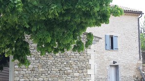 A stone building with a window and a door.