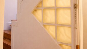 A staircase with a white railing and a glass panel.
