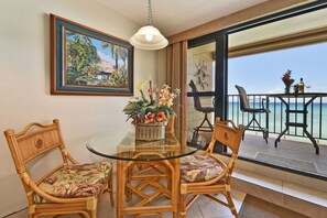Enjoy a meal with a view from the dining table, surrounded by wicker chairs and a beautiful ocean view.