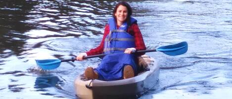 A person in a small inflatable boat on a body of water.
