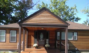 A two-story wooden house with a front porch and a small front yard. - Prime location - Ranch House on Seneca Lake (Romulus)