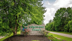 A sign for Edgewater Resort surrounded by lush greenery and a road. - Bourbon Trails, Fishing and Relaxing - Taylorsville Lake has it all! (Taylorsville)