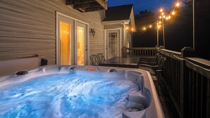 A hot tub on a deck with string lights, a covered patio, and a wooden railing. - Bourbon Trails, Fishing and Relaxing - Taylorsville Lake has it all! (Taylorsville)