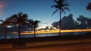 A sunset view with palm trees and a beach. -  Gorgeous 360° Oceanfrnt Views* In the heart Famous Broadwlk*$Free Off St Park$* (Hollywood)