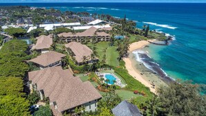 An aerial view of a resort with multiple buildings, a beach, and a swimming pool. - Lanikai 232 “Seascape” | Ocean View | Central A/C | Sleeps 4 (Kapaa)