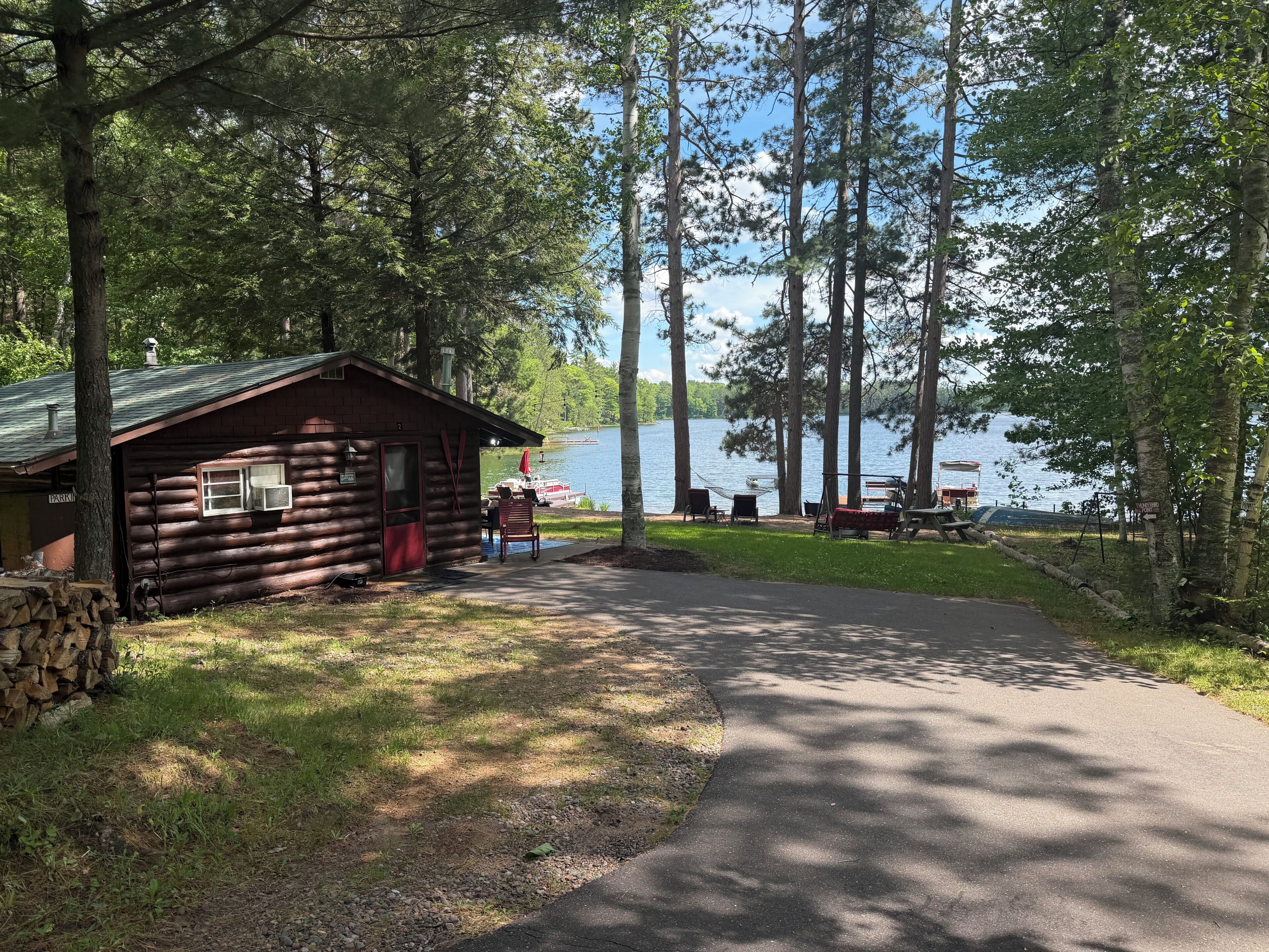A cabin with a porch, a dock, and a lake view.