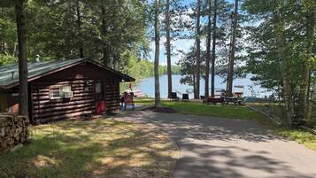 A cabin with a porch, a dock, and a lake view.
