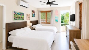 A hotel room with two beds, a ceiling fan, an air conditioner, a TV, and a balcony with a view of greenery. - Surfing Privacy and Relaxation!  Wi-Fi, full A/C! (Rincon)