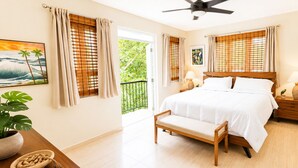 A bedroom with a bed, bedside tables, a bench, a ceiling fan, and a balcony view. - Surfing Privacy and Relaxation!  Wi-Fi, full A/C! (Rincon)
