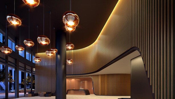 A spacious lobby with modern pendant lighting, a curved staircase, and a reception desk. - Wyndel Apartments Riverside on Collins (Docklands)