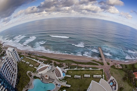 A resort with a pool, beach access, and ocean views.