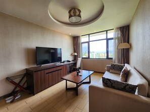 Deluxe Room, 1 King Bed | Living area | 32-inch flat-screen TV with satellite channels, TV - Dmall Hotel (Kigali)
