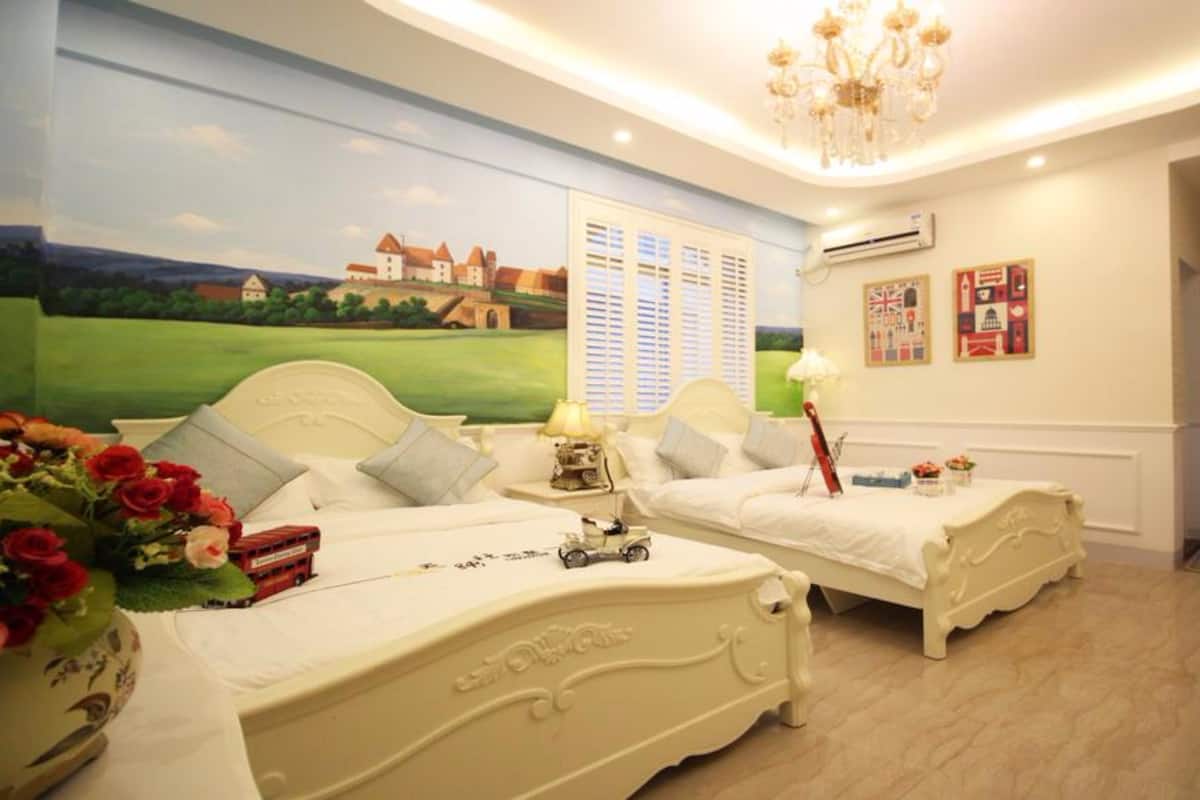 A hotel room with two beds, a chandelier, a mural of a castle, and a door labeled "Secret Home".