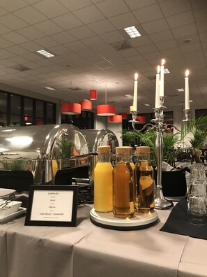 Enjoy a meal in our dining area with a beautifully set table and a selection of beverages.