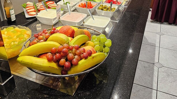 A buffet with various food items including fruits, vegetables, and dips. - Hotel Löwen (Meckenbeuren)