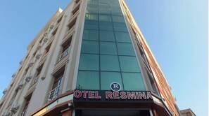 A hotel named "OTEL RESMINA" with a modern glass facade and a visible logo. - Resmina Hotel (Van)