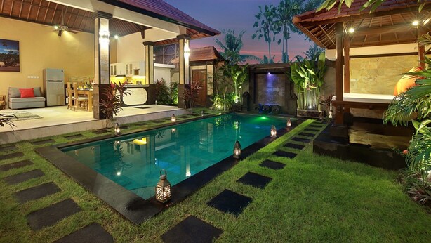 A modern house with a swimming pool, outdoor seating, and a well-maintained garden. - Concetta Villa Seminyak Beachside (Seminyak)