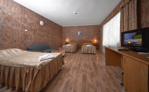 A hotel room with two beds, a desk with a TV, and two bedside lamps. - Akord Business Hotel (Sofia)