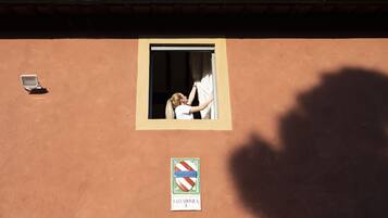 A building facade with a window, a sign reading "Salvadonica I.", and a shadow of a person.