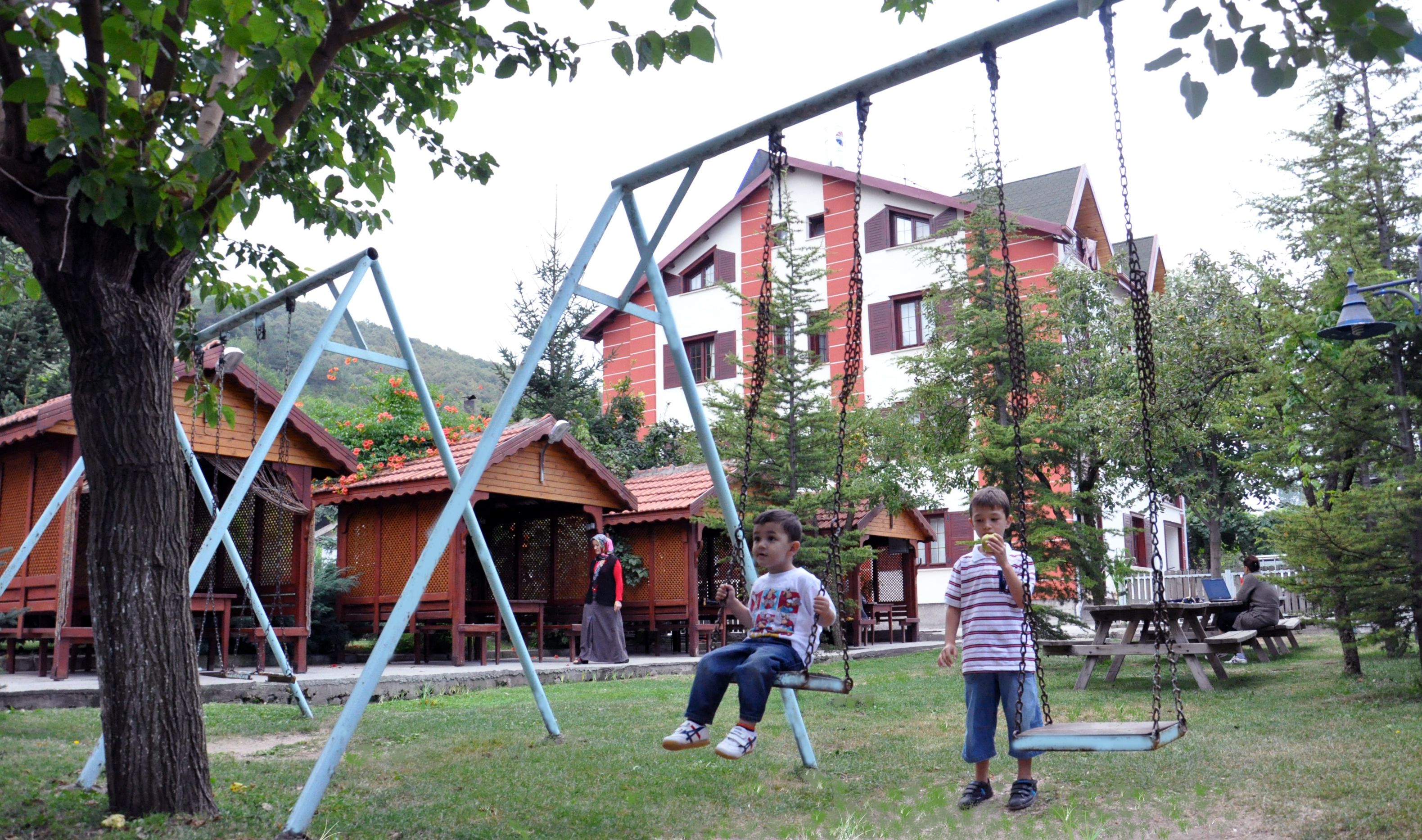 A playground with swings and a picnic table.