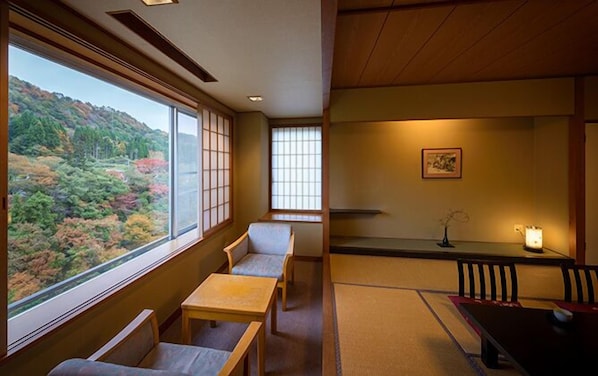 A traditional Japanese room with tatami flooring, a low table, and a bench.
