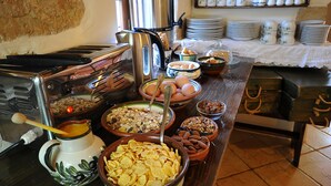 A buffet table with various food items and kitchen appliances. - Elia Traditional Hotel & Spa (Platanias)