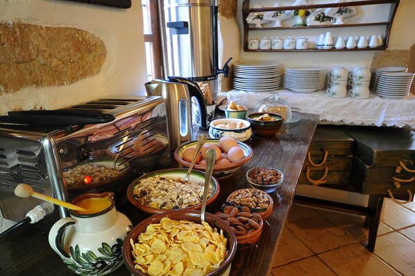 A buffet table with various food items and kitchen appliances. - Elia Traditional Hotel & Spa (Platanias)