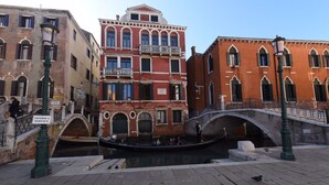 A canal with a gondola, a bridge, and buildings with balconies. - 40.17 San Marco (Venice)
