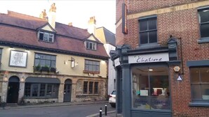 A street view with a building labeled 'Chatime' and another building with a sign 'The Red Lion'. - Ali Inn (Oxford)
