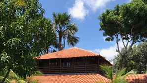 A two-story building with a red-tiled roof, surrounded by well-maintained hedges and flowering plants. - Portal do Sol Lençóis Pousada (Barreirinhas)