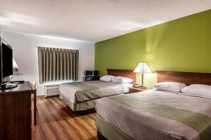 A hotel room with two beds, a desk with a computer, a TV, and a lamp. - Motel 6 Petersburg, VA - Fort Lee (Petersburg)