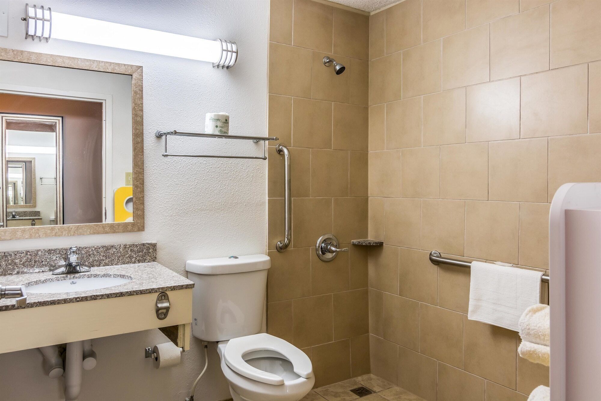 A bathroom with a toilet, sink, and shower.