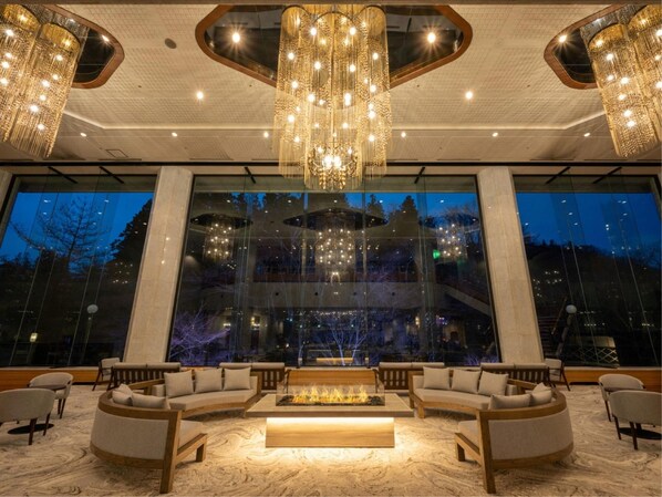A spacious lobby with a central seating area, large windows, and modern chandeliers. - Akiu Grand Hotel (Sendai)