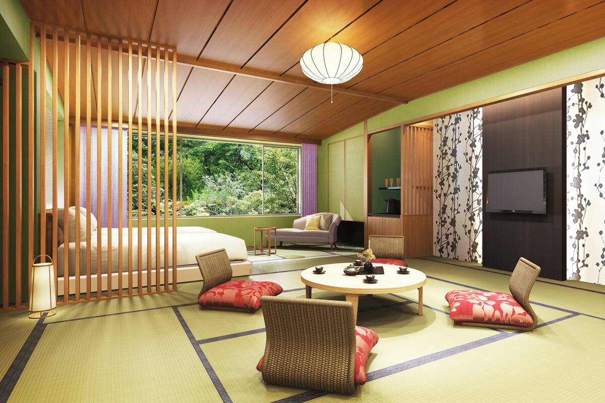 A traditional Japanese-style room with tatami flooring, a low table, and a sofa.