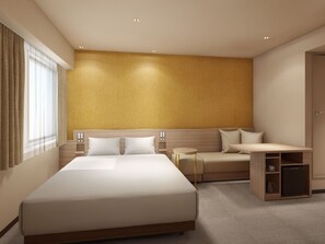 A modern hotel room with a large bed, a sofa, a small table, and a built-in bookshelf. - Via Inn Shimonoseki (Shimonoseki)