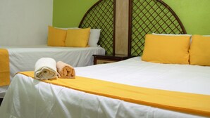 A hotel room with two beds, each with white linens and yellow pillows. - Hotel Jordan (Coatzacoalcos)
