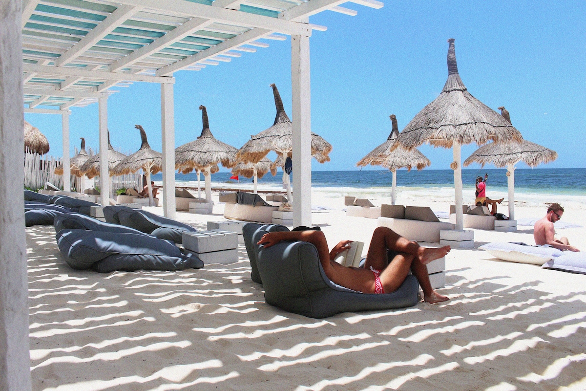 row of sun loungers in a beautiful white beach of Coco Unlimited