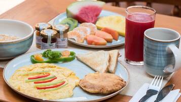 A breakfast plate with eggs, toast, and a slice of ham.