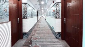 A corridor with patterned walls and doors, leading to a staircase. - Yiwu Chuzhou Hotel (Jinhua)