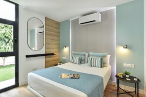 A modern bedroom with a bed, a bedside table, a mirror, and an air conditioning unit.