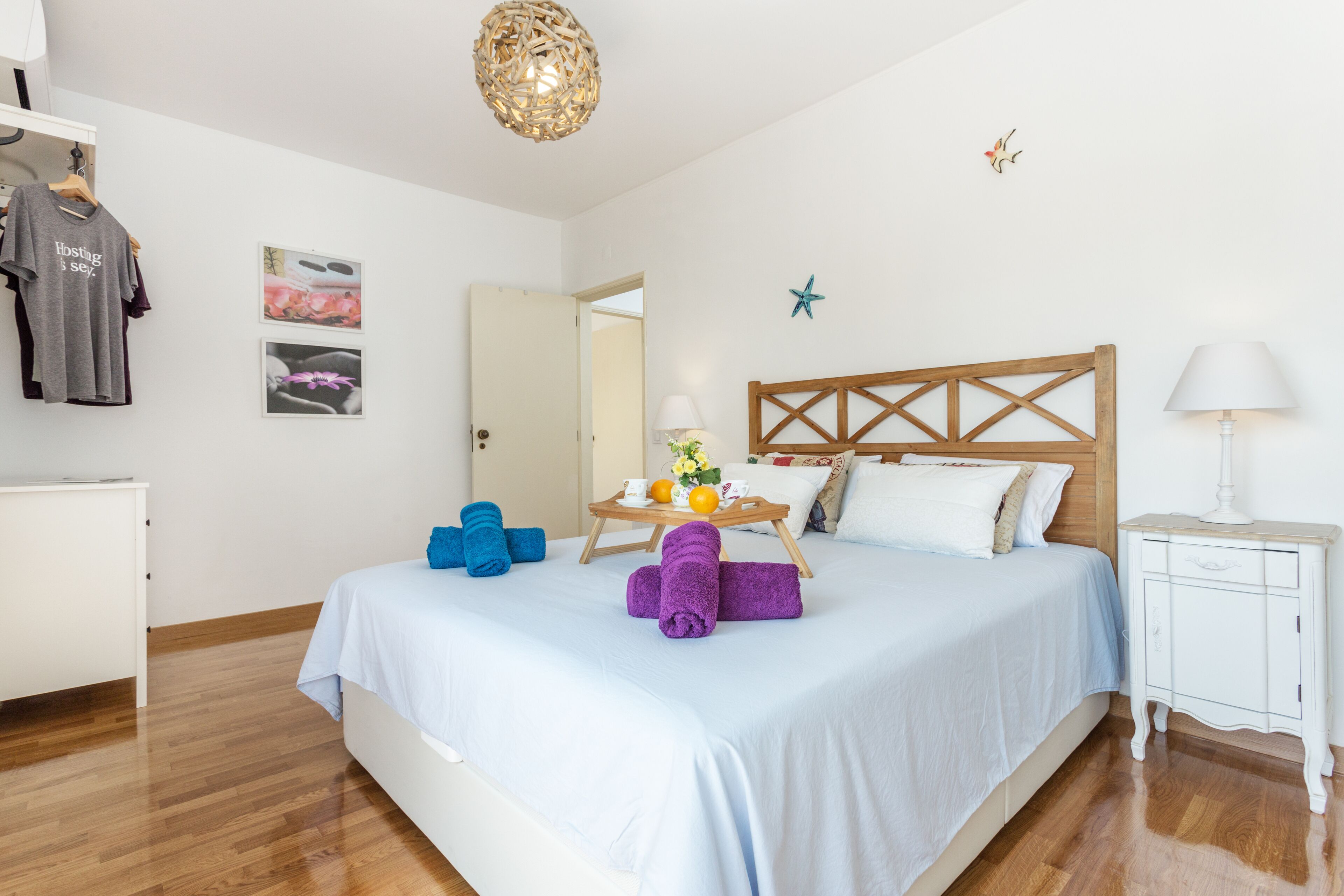 A neatly arranged bedroom with a bed, bedside table, and a wardrobe.