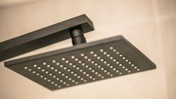 A modern, rectangular showerhead with a sleek, black design.