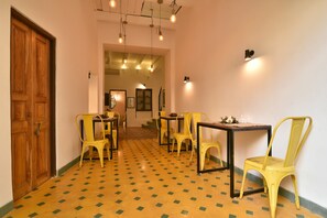 Stunning hallway leads to a dining area with a table and chairs.