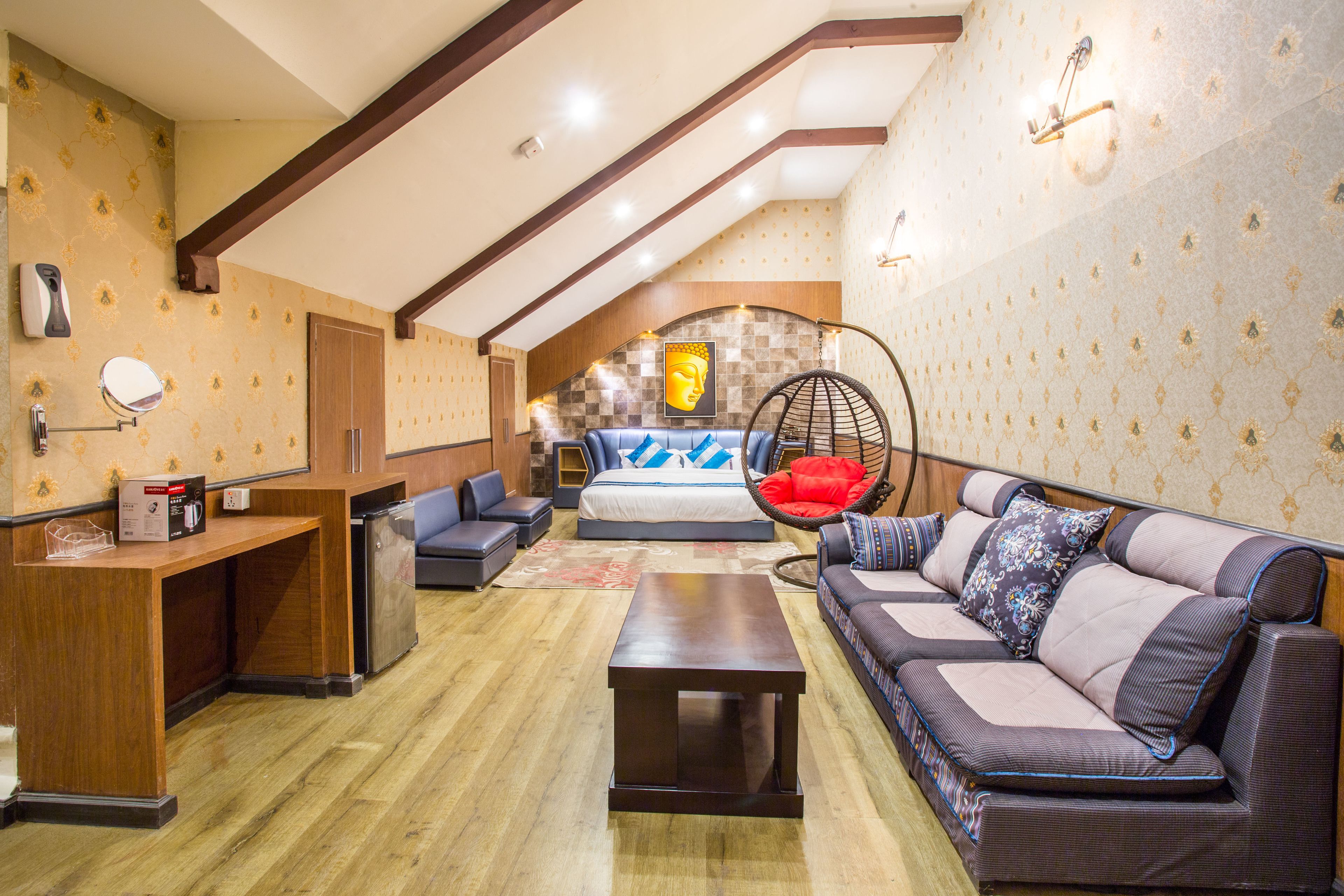 A spacious room with a wooden floor, a sofa, a hanging chair, a bed, and a desk.