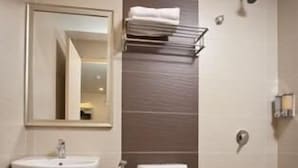 A bathroom with a white sink, a toilet, and a towel rack. - Lotus Hotel KL Sentral (Kuala Lumpur)