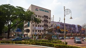 A Lotus Hotel with a modern facade, located in a busy urban area with visible traffic and street lamps. - Lotus Hotel KL Sentral (Kuala Lumpur)