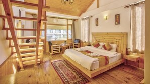 A wooden bedroom with a loft bed, a desk, and a chair. - Hotel Wild Rose (Manali)