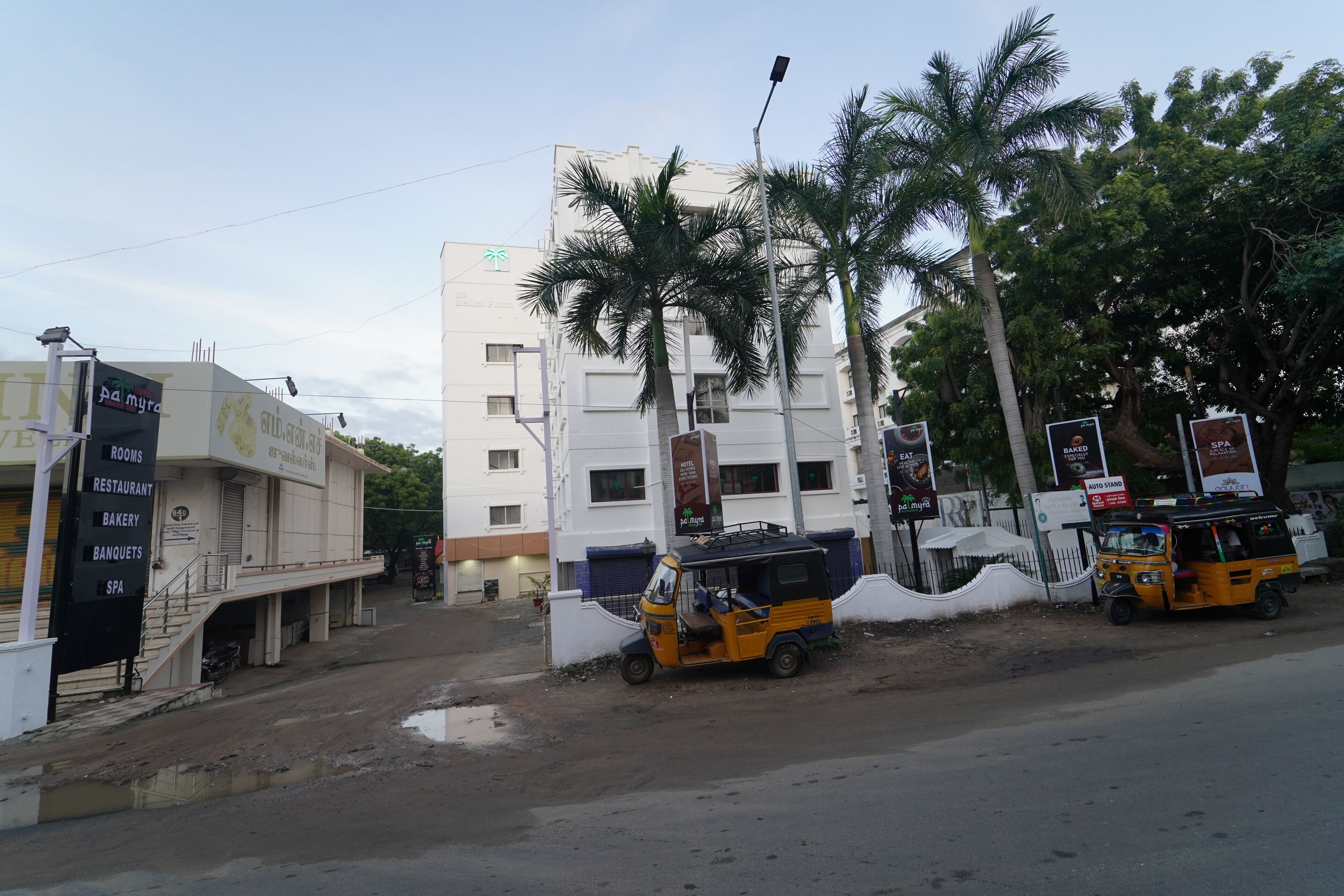 A multi-story building with a sign for 'rooms, restaurant, bakery, banquets, spa'.