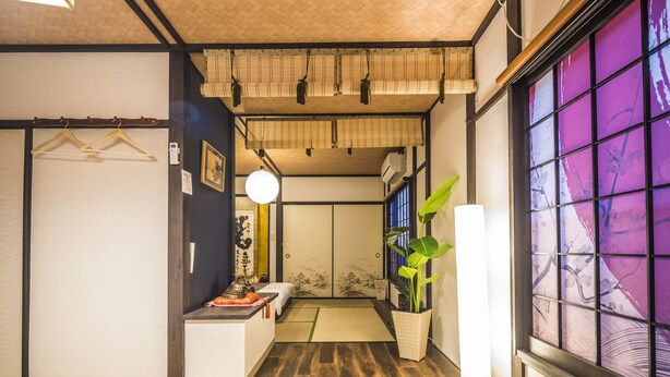 A traditional Japanese room with tatami flooring, shoji screens, and a sliding door. - Kyo Oyado Hana (Kyoto)