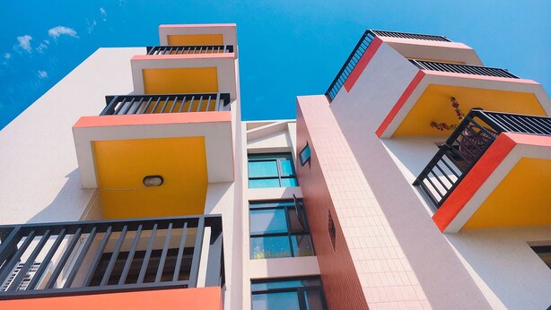 A multi-story building with balconies and large windows. - 198 Red Hat B&B (Magong)